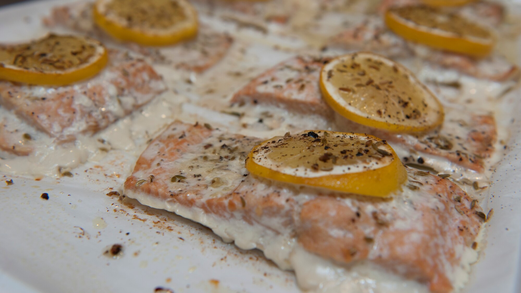 Baked salmon, fresh out of the oven, sits on a cooking tray March 31, 2015, at Dover Air Force Base, Del. The salmon was prepared by Airman attending a “Dorm to Gourm” Leadership Pathways class. (U.S. Air Force photo/Airman 1st Class Zachary Cacicia)