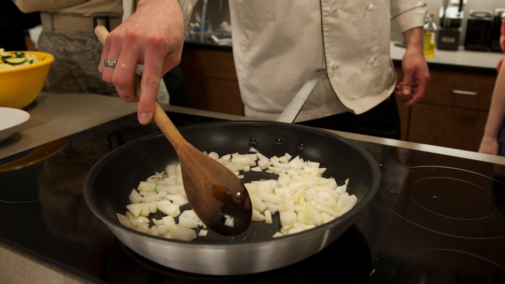 Jeffrey Moore, 436th Force Support Squadron, stirs diced onions March 31, 2015, at Dover Air Force Base, Del. Moore acted as a guest chef for this session. (U.S. Air Force photo/Airman 1st Class Zachary Cacicia)