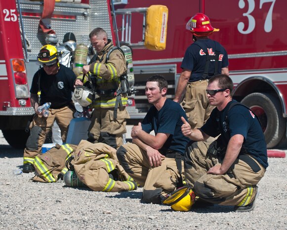 A firefighter from the Merced County Fire Department’s Castle Fire Station 62, Atwater, Calif., gives a thumbs up during training at the burn pit on Nellis Air Force Base, Nev., March 27, 2015. MCFD firefighters extinguished interior and exterior aircraft fires under the supervision of the 99th Civil Engineer Squadron Fire Emergency Services Flight. (U.S. Air Force photo by Staff Sgt. Siuta B. Ika)