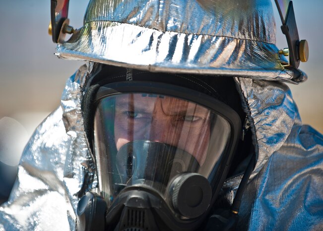 Robert Caswell, 99th Civil Engineer Squadron Fire Emergency Services Flight firefighter, prepares himself for training at the burn pit on Nellis Air Force Base, Nev., March 27, 2015. Caswell and other Nellis-Creech firefighters are required to complete aircraft fire extinguishing training at the burn pit annually to stay flightline certified and ensure their preparedness to respond rapidly to aircraft emergencies. (U.S. Air Force photo by Staff Sgt. Siuta B. Ika)