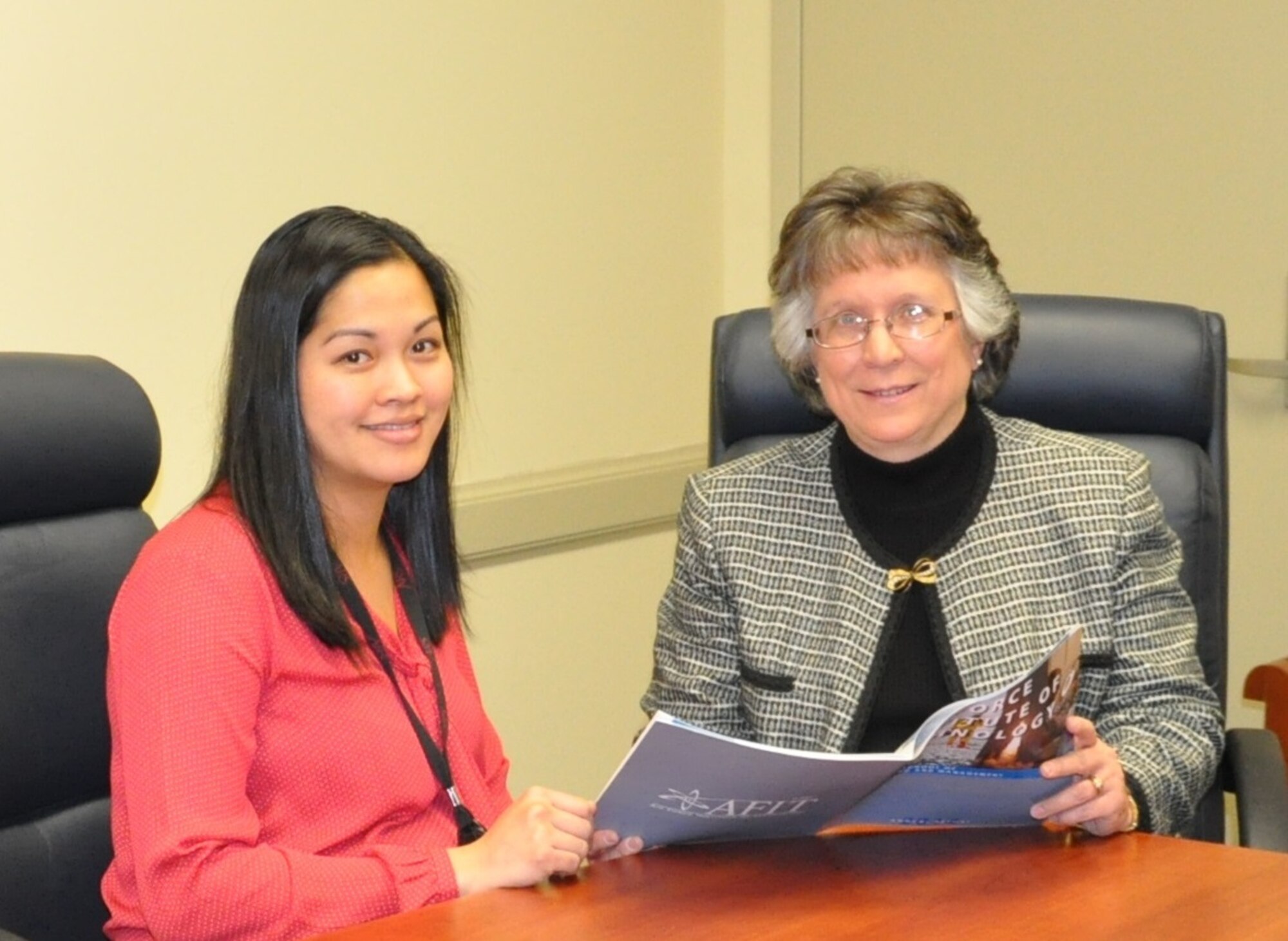 Dr. Heidi RIes, AFIT's Dean for Research, consults with Lori Kinder on the preparation of the annual AFIT Research Report, which significantly improves the communication of research capabilities.
