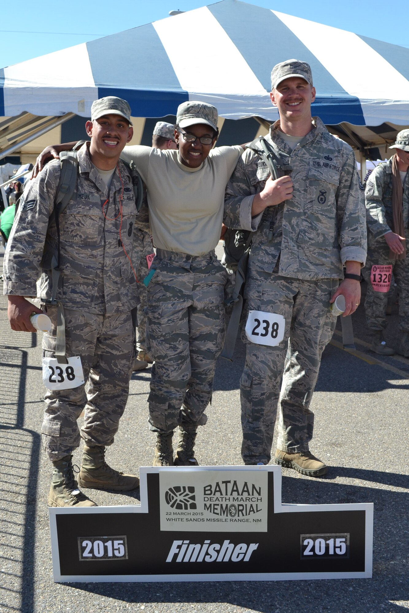 Tech. Sgt. Joel Beuke and Senior Airman Christian Mejia who competed in the military heavy division, and Airman 1st Class Latrell Nickens celebrate their completion of the Bataan Memorial Death March in New Mexico March 22. The trio are all Defenders from the 721st Security Forces Squadron. (Courtesy photo)
