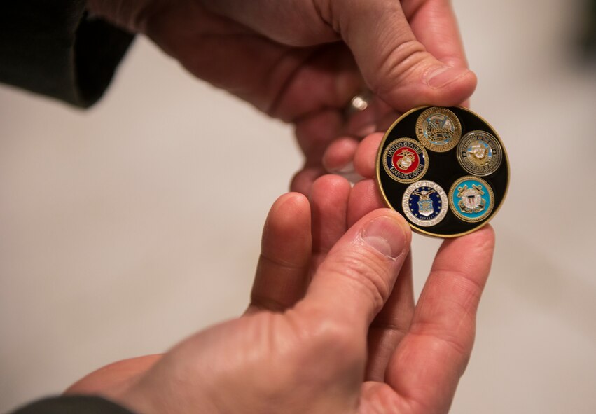 U.S. Air Force Maj. Gen. H. D. Polumbo, Jr., Ninth AF commander, holds a national athletic trainers association challenge coin March 27, 2015, at Moody Air Force Base, Ga. Polumbo received the coin from the staff of the Warrior Athlete Center of Excellence. (U.S. Air Force photo by Airman 1st Class Ceaira Tinsley/Released)