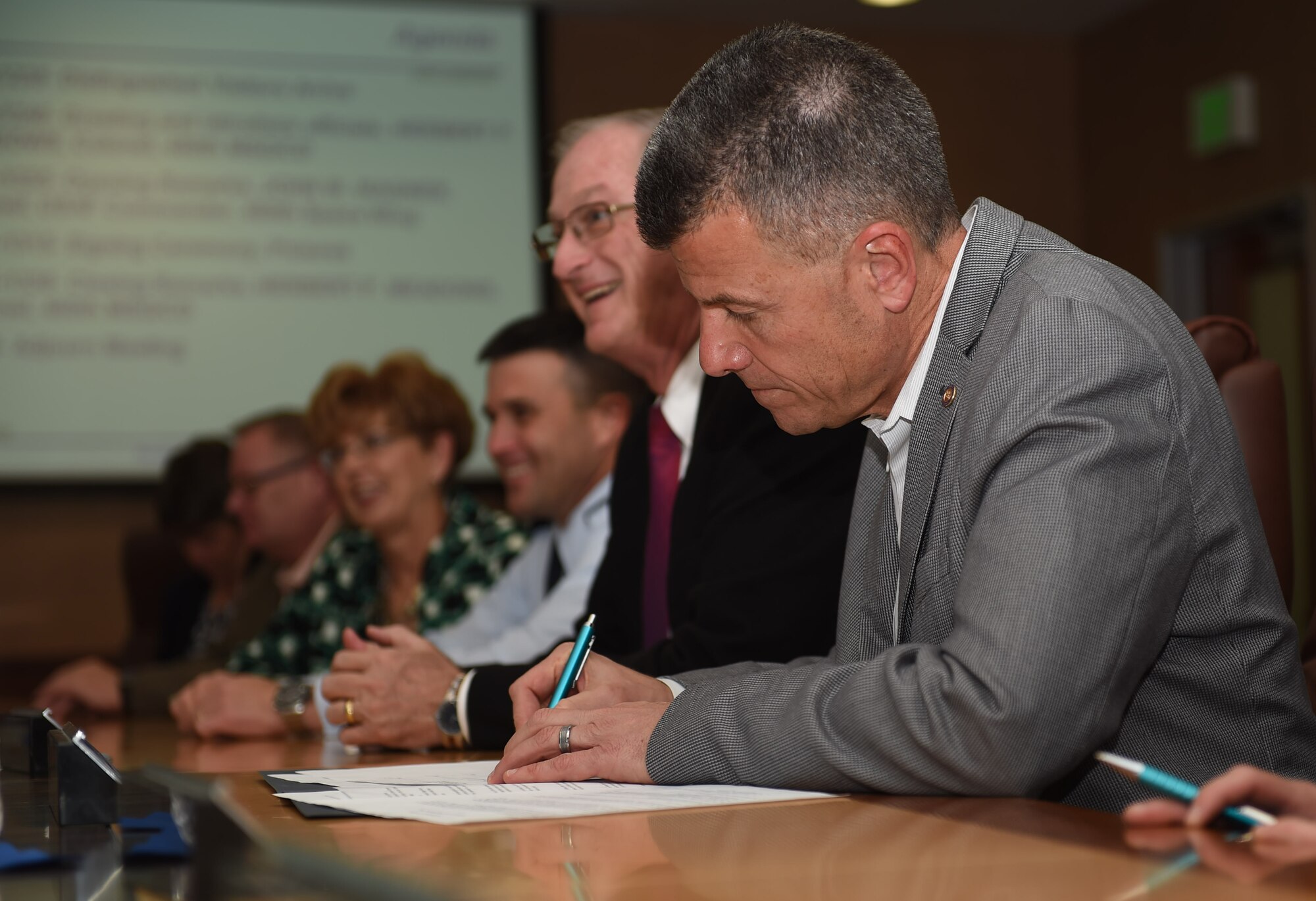 Team Buckley and local community leaders sign the Buckley Partnership Steering Group charter March 31, 2015, at the 460th Space Wing Headquarters building on Buckley Air Force Base, Colo. The document declares partnerships and collaboration between Buckley AFB and local communities. (U.S. Air Force photo by Airman 1st Class Samantha Saulsbury/Released)