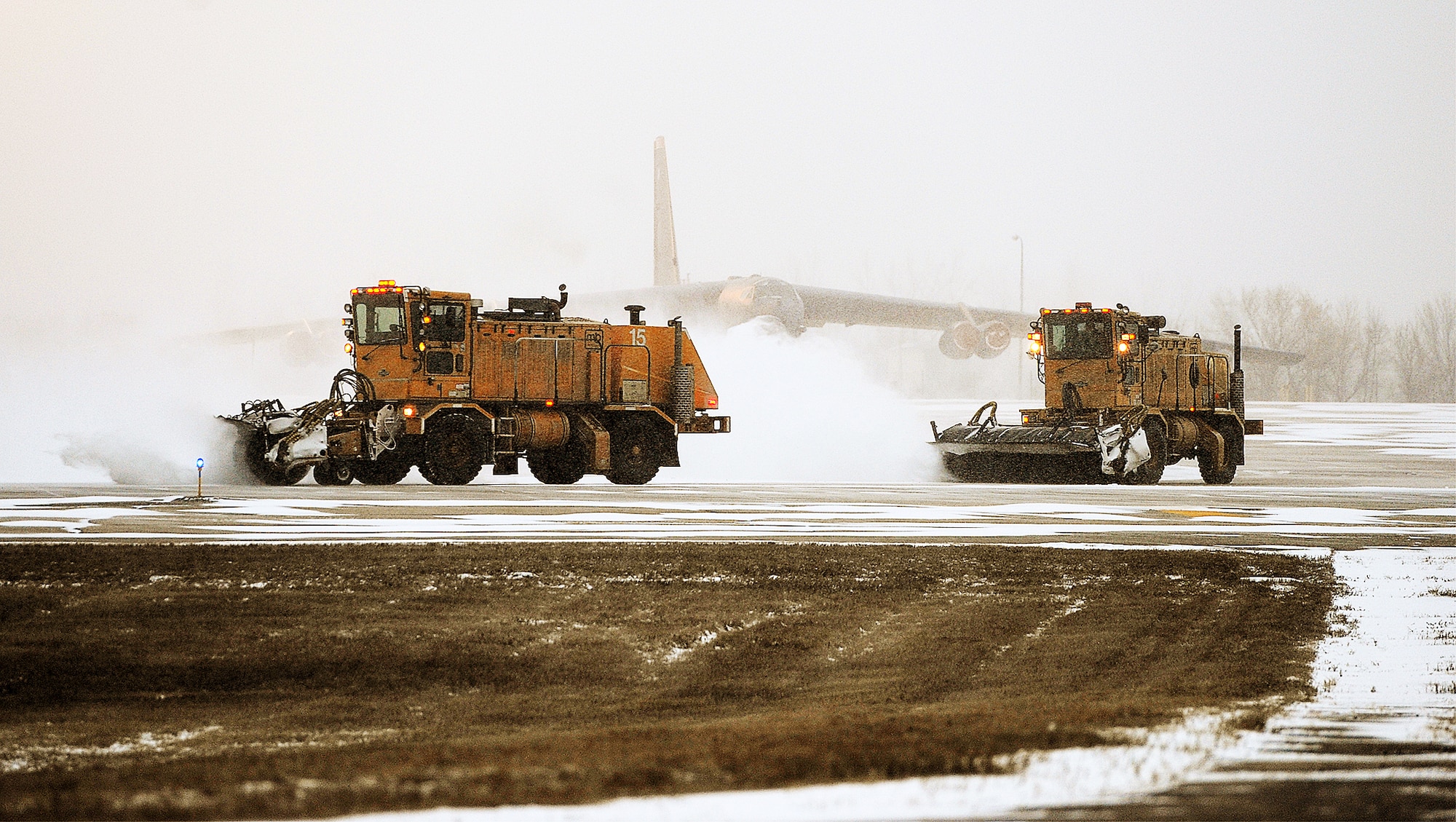 Snow plows clear the runway for B-52H Stratofortresses to take off during the rapid launch portion of the Prairie Vigilance exercise on Minot Air Force Base, N.D., March 27, 2015. Heavy equipment engineers use snow plows, brooms and snow blowers to rid pavement of snow and ice. (U.S. Air Force photo/Senior Airman Kristoffer Kaubisch)