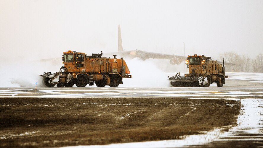 Snow plows clear the runway for B-52H Stratofortresses to take off during the rapid launch portion of the Prairie Vigilance exercise on Minot Air Force Base, N.D., March 27, 2015. Heavy equipment engineers use snow plows, brooms and snow blowers to rid pavement of snow and ice. (U.S. Air Force photo/Senior Airman Kristoffer Kaubisch)
