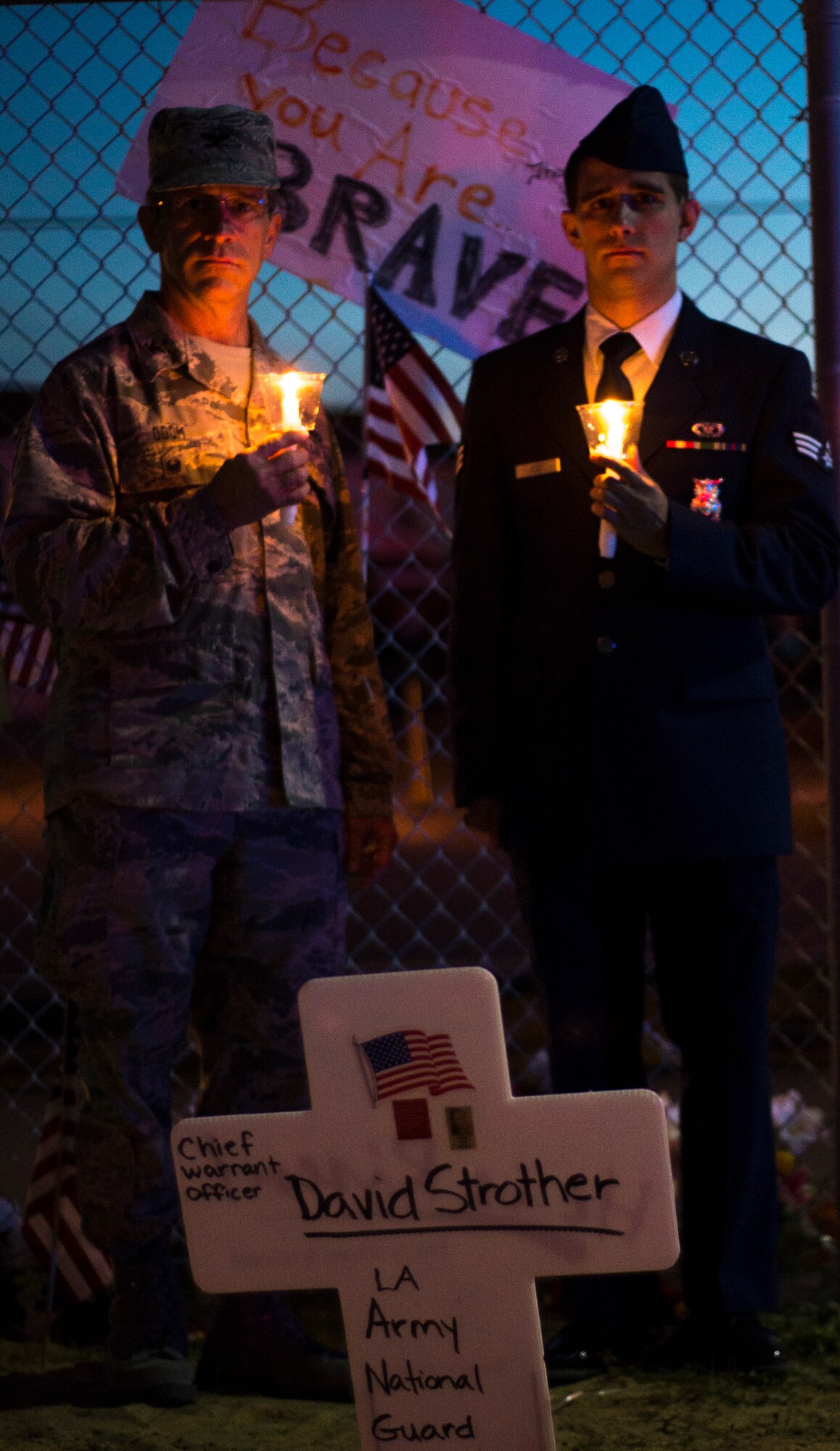 Col. Gene Odom (left), and his son Senior Airman Zachary Odom (right), a 919th Special Operations Civil Engineer Squadron firefighter, take a moment to remember the fallen servicemen March 31 at Destin Executive Airport, Fla.  Approximately 200 from the Destin community held a candlelight memorial service honoring the fallen servicemen in the Black Hawk UH-60 crash in Santa Rosa Sound on March 11.  (U.S. Air Force photo/Tech. Sgt. Jasmin Taylor)