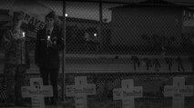 Col. Gene Odom (left), and his son Senior Airman Zachary Odom (right), a 919th Special Operations Civil Engineer Squadron firefighter, take a moment to remember the fallen servicemen March 31 at Destin Executive Airport, Fla.  Approximately 200 from the Destin community held a candlelight memorial service honoring the fallen servicemen in the Black Hawk UH-60 crash in Santa Rosa Sound in Santa Rosa Sound on March 11.  (U.S. Air Force photo/Tech. Sgt. Jasmin Taylor)