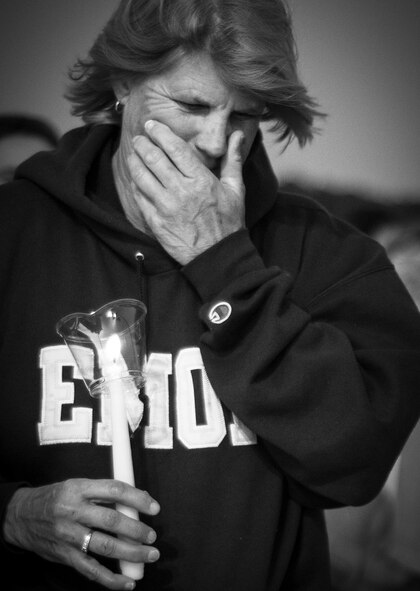A member of the Destin community holds a candle at the memorial to remember the fallen servicemen March 31 at Destin Executive Airport, Fla.  Approximately 200 from the Destin community held a candlelight memorial service honoring the fallen servicemen in the Black Hawk UH-60 crash in Santa Rosa Sound on March 11.  (U.S. Air Force photo/Tech. Sgt. Jasmin Taylor)