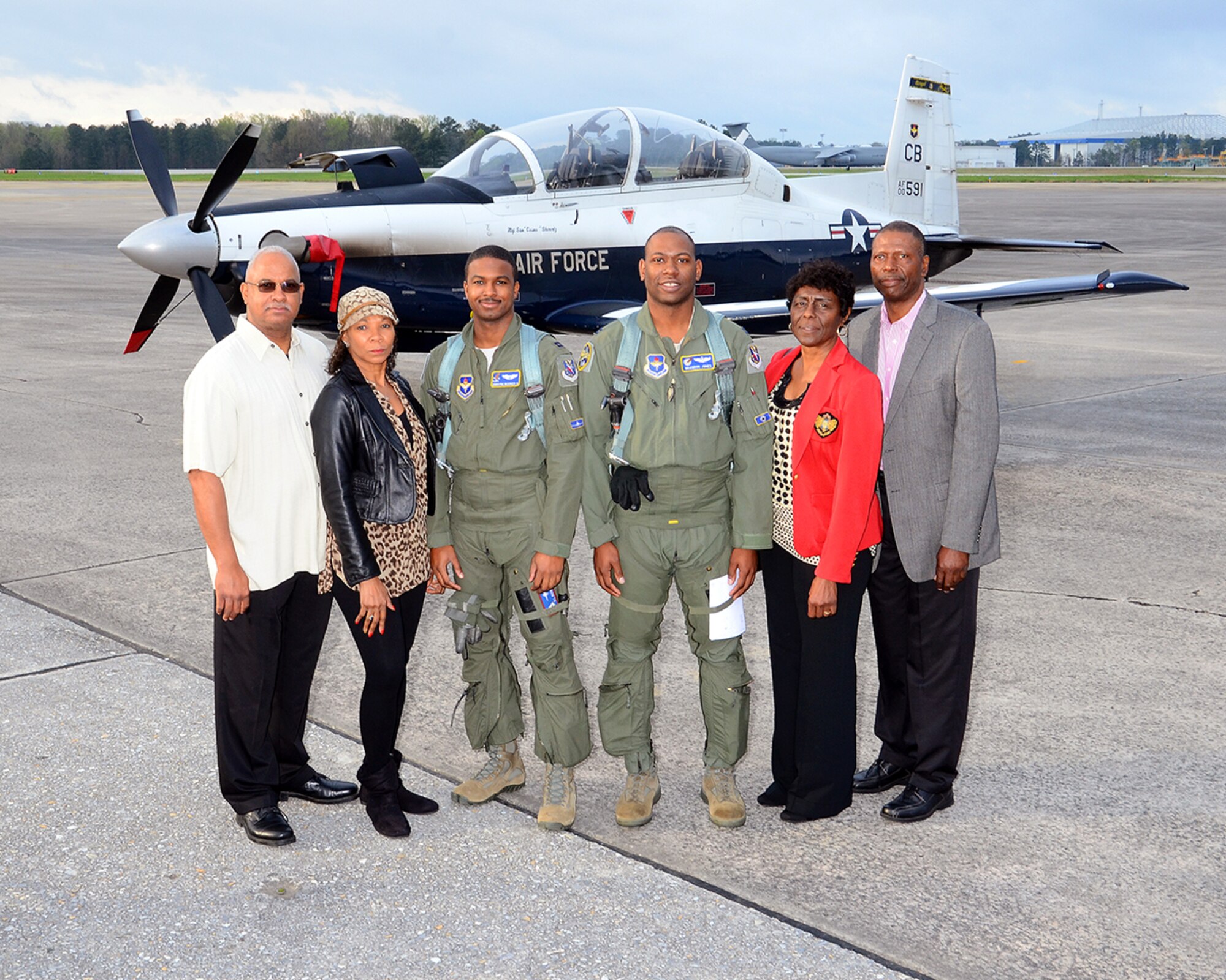 Dwayne and Doris Booker, and Bob and Carolyn Jones greet Capts. Dwayne L. Booker II and Brandon Jones, 14th Flying Training Wing instructor pilots, upon their landing at Dobbins Air Reserve Base, Georgia, in route to the first-ever Morehouse College Joint-Service Military Crown Forum March 26 in Atlanta, Georgia. The forum consisted of a panel of four of the nation’s highest ranking military officers discussing topics ranging from the U.S. military’s role in dealing with international affairs, to how their character, integrity, leadership and community service helped them advance to the highest levels of their professions. (U.S. Air Force photo/Brad Fallin)