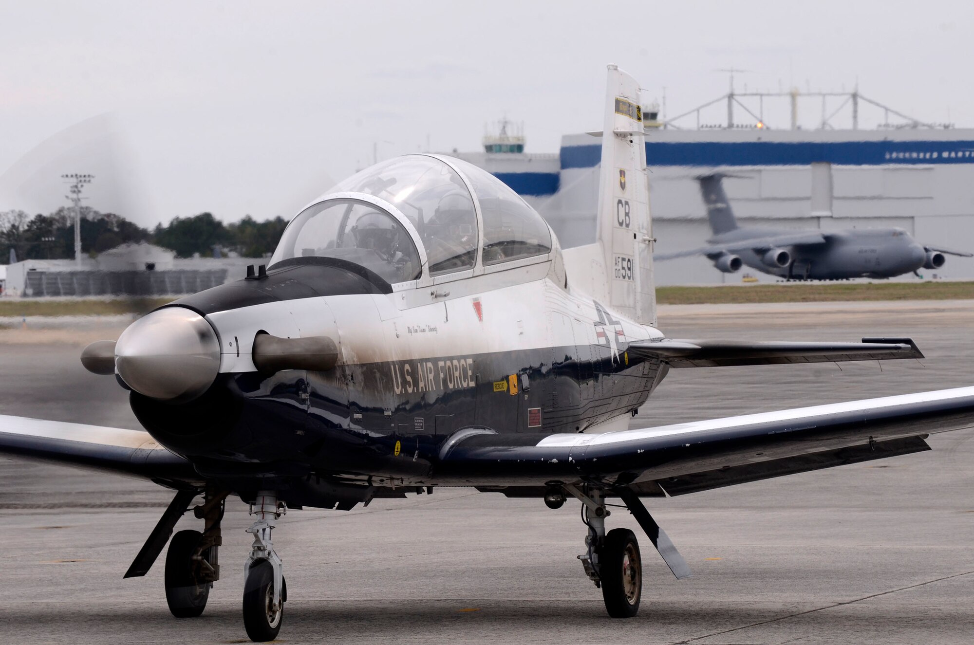 Capts. Dwayne L. Booker II and Brandon Jones, 14th Flying Training Wing instructor pilots, take off from Dobbins Air Reserve Base, Georgia, in a T-6 aircraft after attending the first-ever Morehouse College Joint-Service Military Crown Forum March 26 in Atlanta, Georgia. The forum, a student-led event, was derived from the vision of the Morehouse ROTC Joint-Services Committee and Crown Forum committee members. (U.S. Air Force photo/Don Peek)