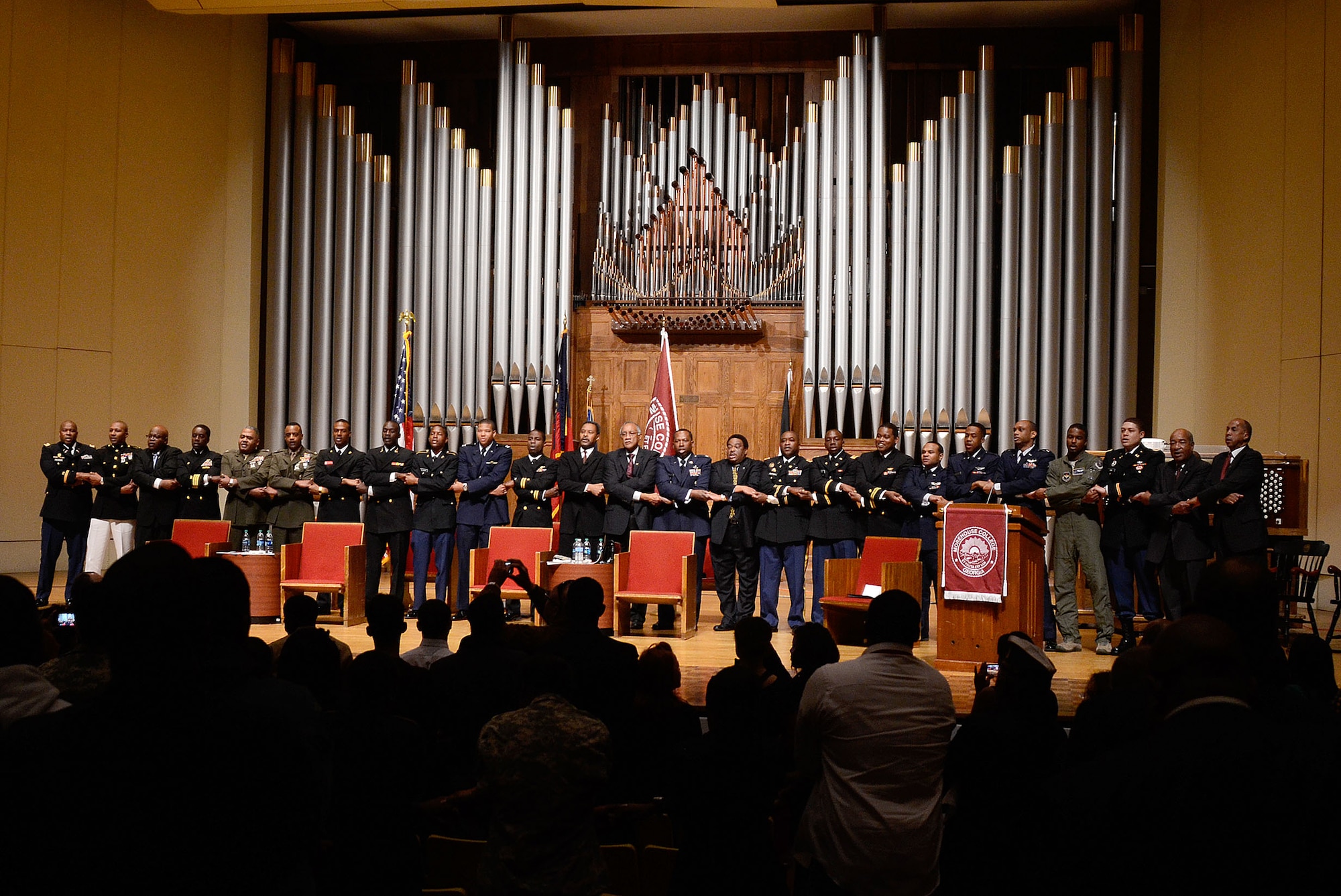 Capt. Dwayne L. Booker, 14th Flying Training Wing instructor pilot, joins alumni and members of the U.S. Armed Forces in singing the college song, Dear Old Morehouse, March 26 at the first-ever Morehouse College Joint-Service Military Crown Forum in Atlanta, Georgia. Booker, a graduate of Morehouse College, said he consistently promotes the military and tries to increase awareness of its many opportunities to minority students. (U.S. Air Force photo/Don Peek)