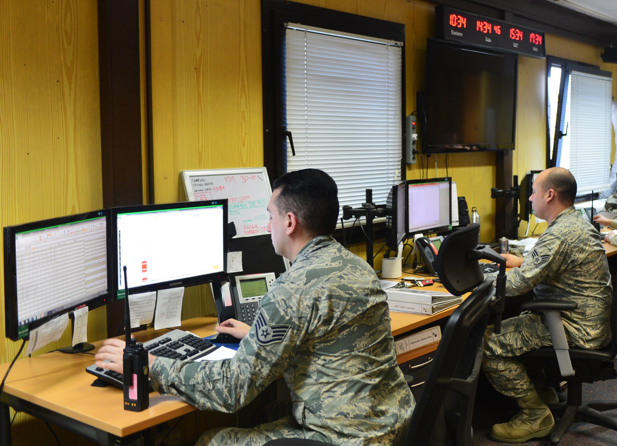 U.S. Air Force Staff Sgt. Curtis Morgan and U.S. Air Force Senior Airman David Hartley, Maintenance Operations Center controllers, monitor flight line operations at Spangdahlem Air Base, Germany, March 25, 2015. The MOC has three eight-hour shifts during the work week to maintain 24-hour operations. (U.S. Air Force photo by 2nd Lt Meredith Mulvihill/Released)