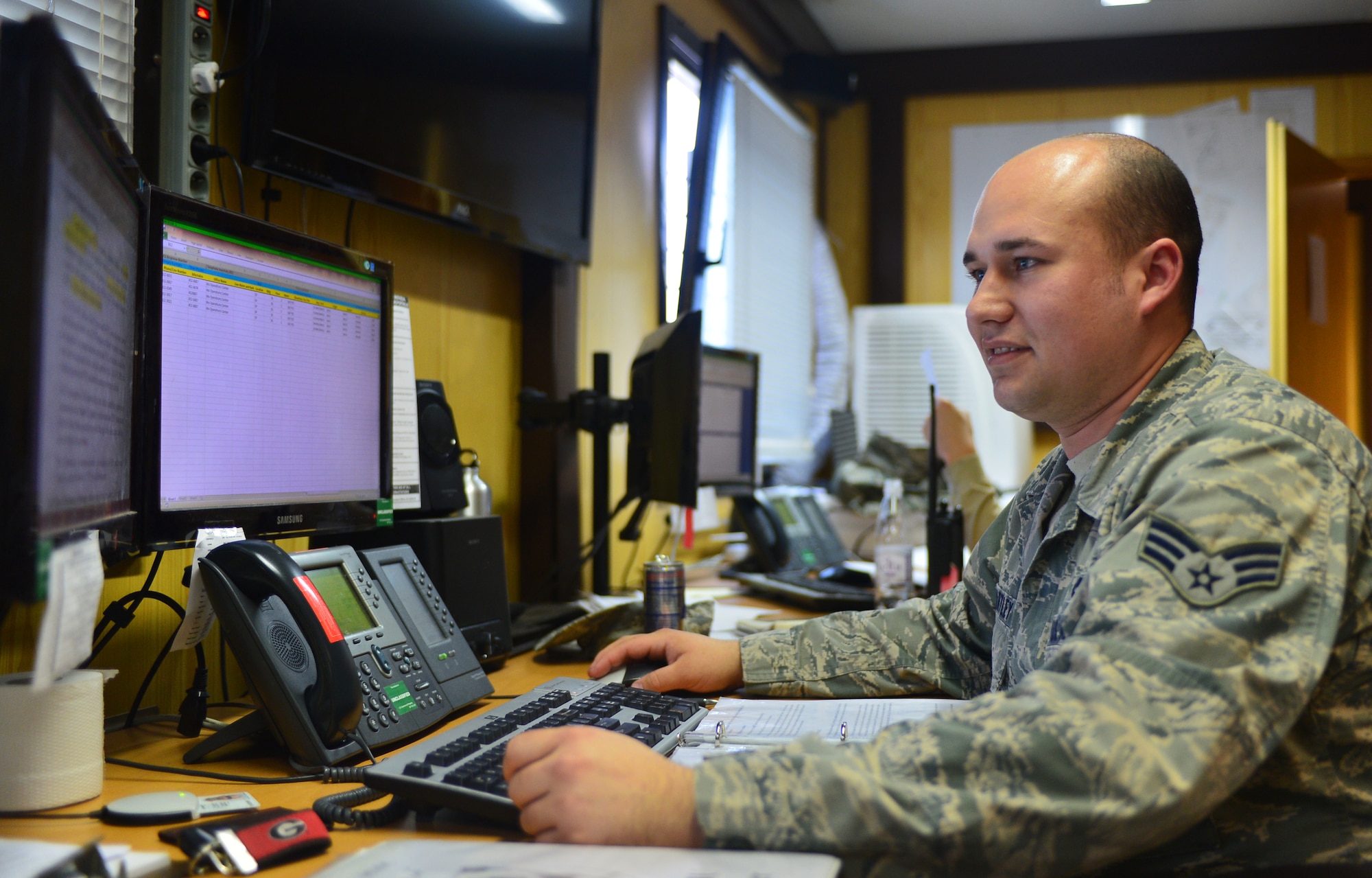 U.S. Air Force Senior Airman David Hartley, a Maintenance Operations Center controller, checks over information in the MOC at Spangdahlem Air Base, Germany, March 25, 2015. Part of the MOC's daily mission is to track the status of all aircraft and equipment on the flight line and coordinate maintenance and logistics support. (U.S. Air Force photo by 2nd Lt Meredith Mulvihill/Released)