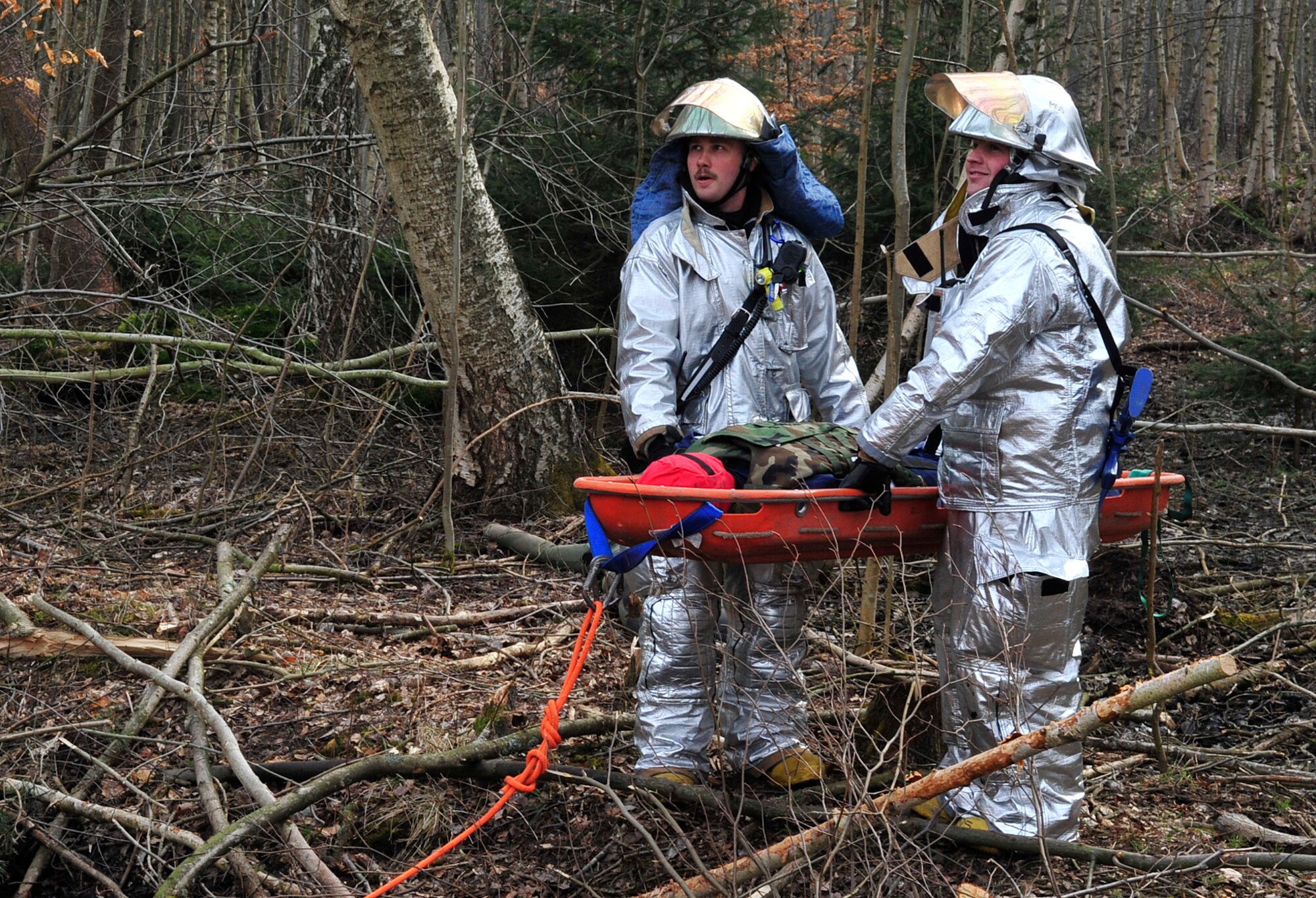 Tech. Sgt. Brian Plemons (left) and Staff Sgt. Tyler McClain, 48th Civil Engineer Squadron firefighters, participate in a fire rescue scenario during Silver Flag 2015 exercise training at Ramstein Air Base, Germany, March 21, 2015. Civil engineer Airmen went through hazardous material, fire response and flightline crater repair scenarios to prepare for real wartime situations. (U.S. Air Force photo/Airman 1st Class Larissa Greatwood)