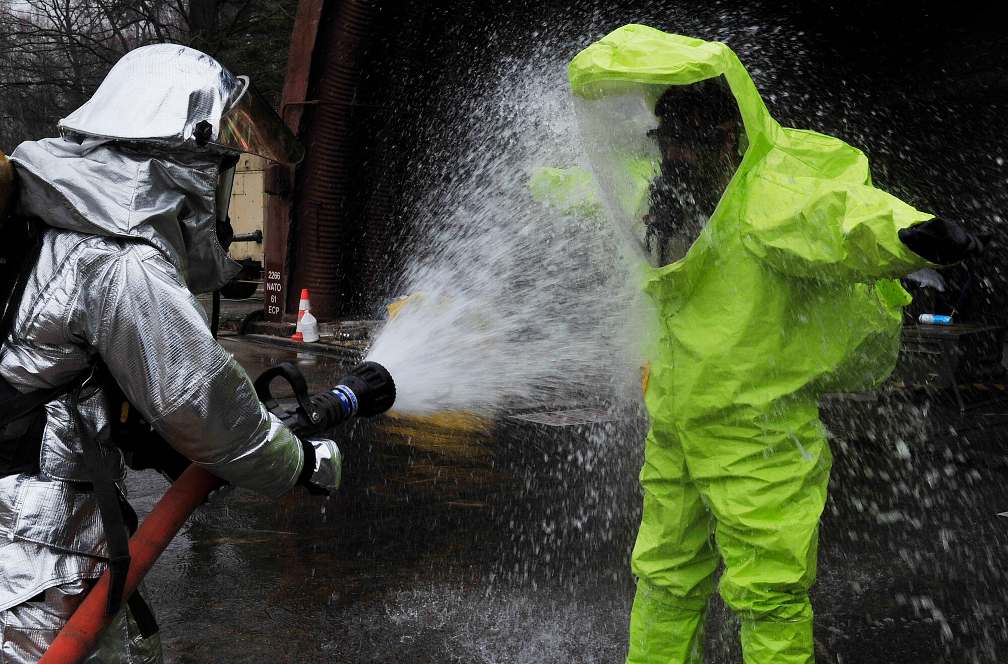 Senior Airman Faisal Farooq, 52nd Civil Engineer Squadron emergency manager, is decontaminated after leaving a building after a simulated fire rescue and chemical spill scenario during Silver Flag 2015 exercise training at Ramstein Air Base, Germany, March 21, 2015. Civil engineer Airmen went through hazardous material, fire response and flightline crater repair scenarios to prepare for real wartime situations. (U.S. Air Force photo/Airman 1st Class Larissa Greatwood)