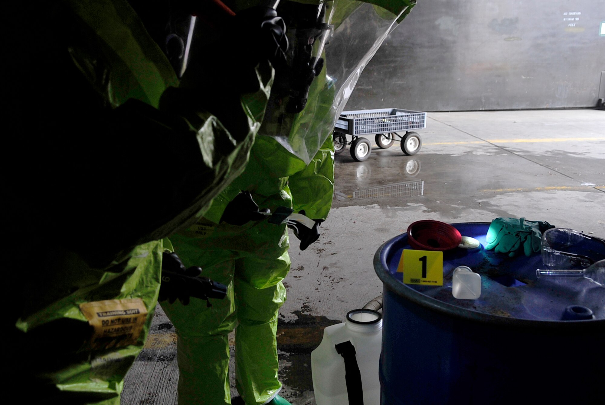 Senior Airman Faisal Farooq, 52nd Civil Engineer Squadron emergency manager, and Airman 1st Class Madeline Setere, 786th Civil Engineer Squadron emergency manager, test chemicals  during a simulated chemical spill during Silver Flag 2015 exercise training at Ramstein Air Base, Germany, March 21, 2015. Civil engineer Airmen went through hazardous material, fire response and flightline crater repair scenarios to prepare for real wartime situations. (U.S. Air Force photo/Airman 1st Class Larissa Greatwood)