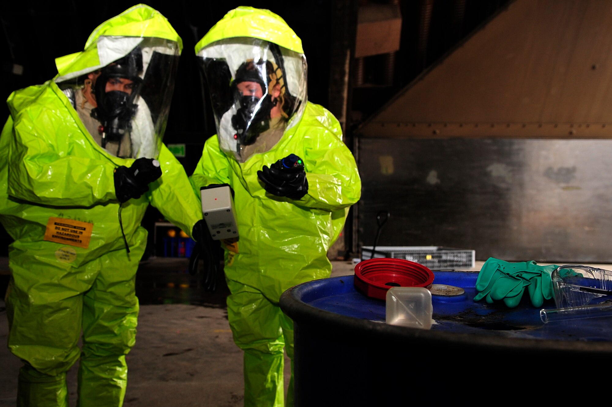 Senior Airman Faisal Farooq (left), 52nd Civil Engineer Squadron emergency manager, and Airman 1st Class Madeline Setere, 786th Civil Engineer Squadron emergency manager, test chemicals during a simulated chemical spill during Silver Flag 2015 exercise training at Ramstein Air Base, Germany, March 21, 2015. Civil engineer Airmen went through hazardous material, fire response and flightline crater repair scenarios to prepare for real wartime situations. (U.S. Air Force photo/Airman 1st Class Larissa Greatwood) 