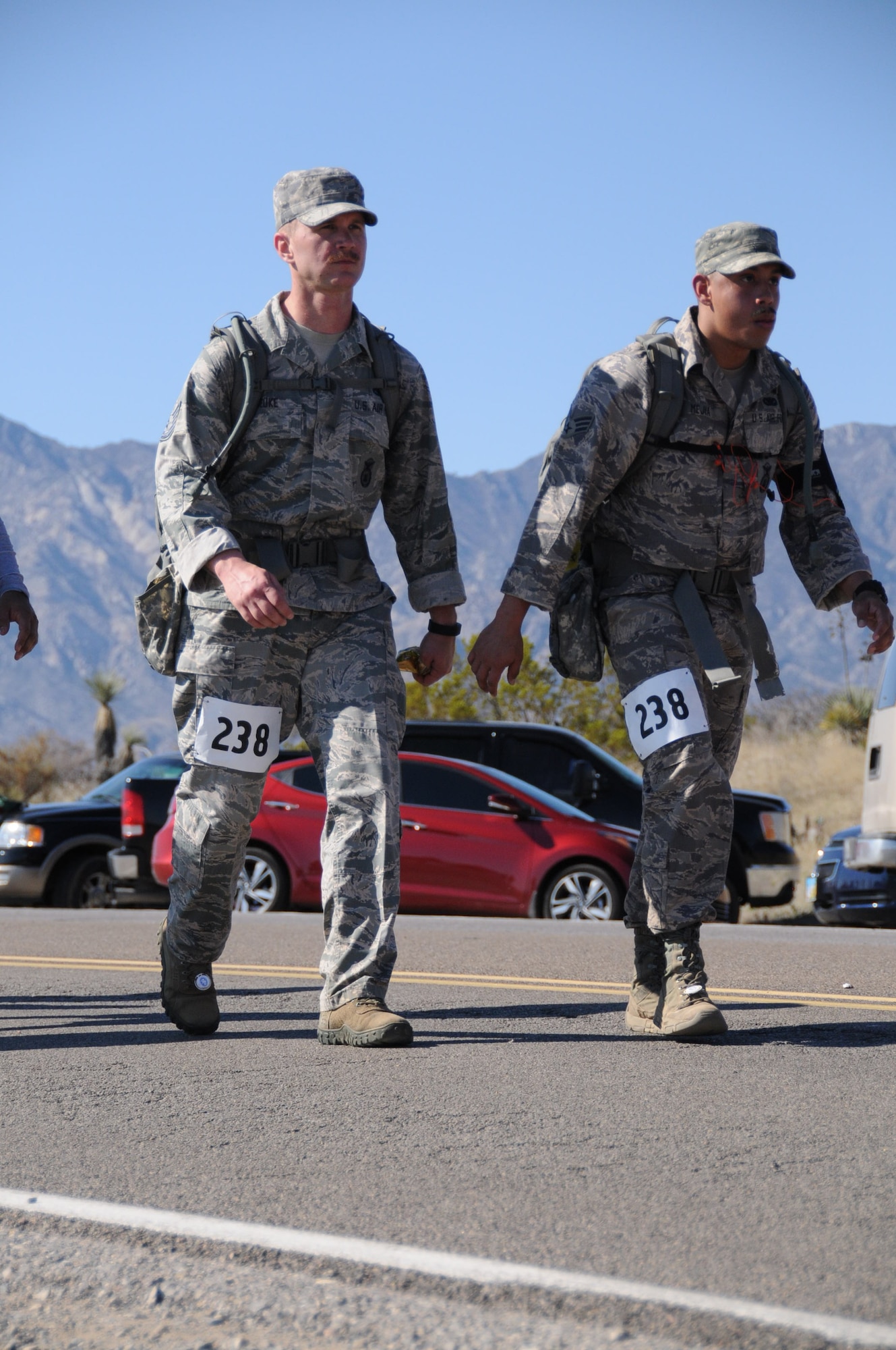 WHITE SANDS MISSILE RANGE, N.M. -- Tech. Sgt. Joel Beuke and Senior Airman Christian Mejia, 721st Security Forces Squadron, participate in the Bataan Death March Memorial March 22. The pair of defenders completed the heavy division, carrying a 35-pound ruck sack the entire 26.2 miles through the desert. (Courtesy photo) 