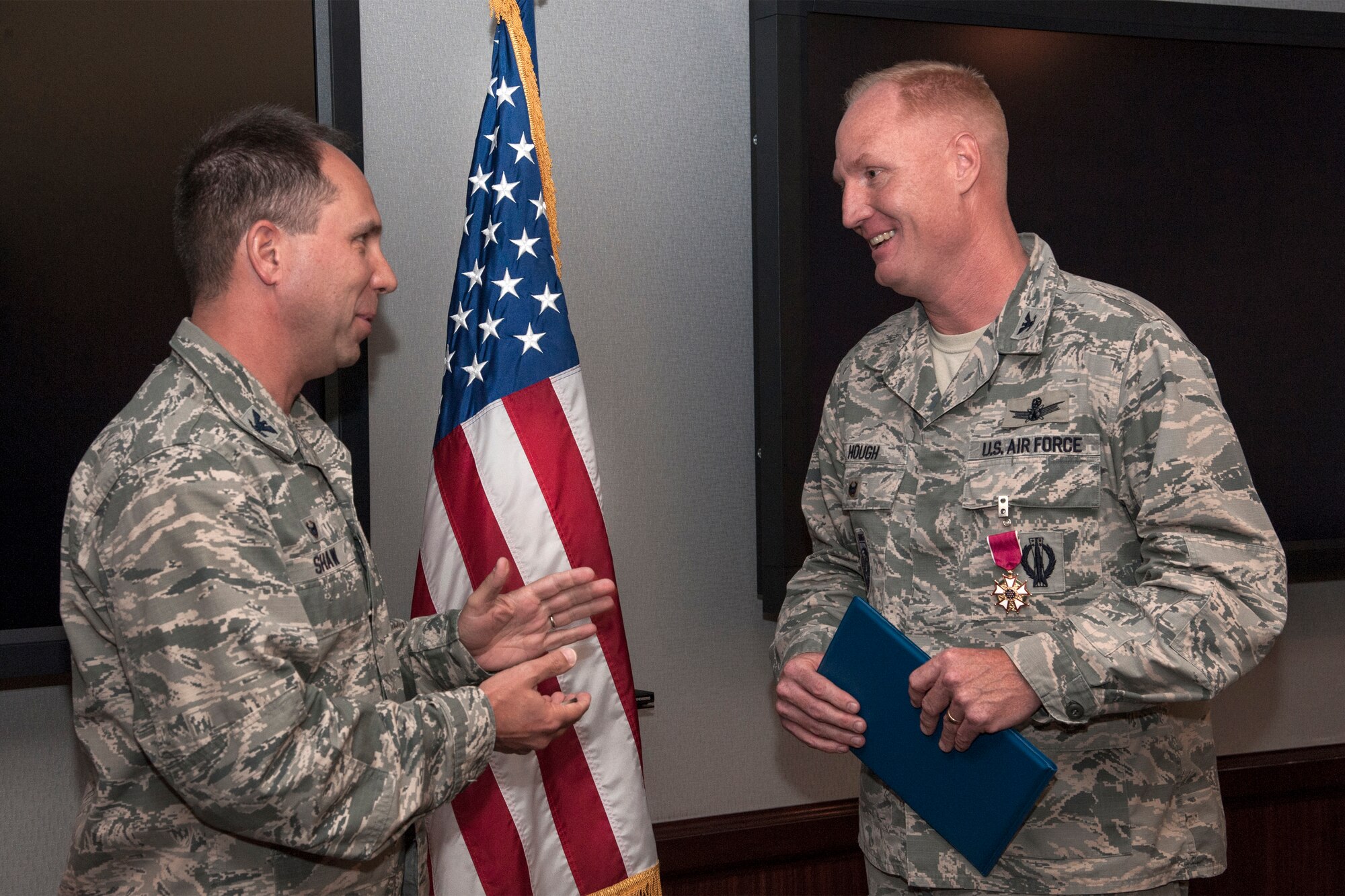 PETERSON AIR FORCE BASE, Colo. – Col. John Shaw (left), 21st Space Wing commander, presents the Legion of Merit award to Col. Michael Hough, outgoing 21st SW vice commander, March 25 in the 21st SW commander’s conference room. Hough distinguished himself in the performance of outstanding service to the United States as vice commander from June 20, 2013 to March 31, 2015. As vice commander, Hough led more than 4,350 personnel at 42 units, spanning 13 time zones and eight countries as they executed the Air Force’s missile warning, missile defense and space surveillance capabilities. (U.S. Air Force photo by Craig Denton)