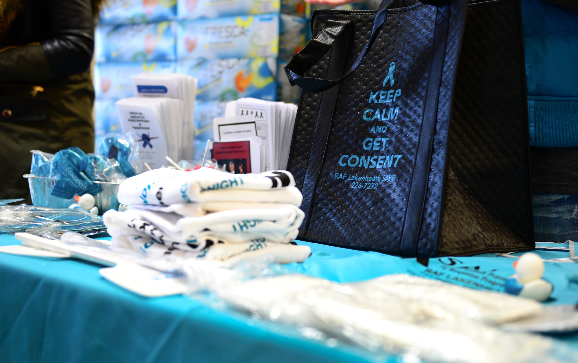 The 48th Fighter Wing Sexual Assault Prevention and Response team kicks off Sexual Assault and Child Abuse Awareness Month at the commissary on Royal Air Force Lakenheath, England, April 1, 2015. This annual observance highlights the efforts that all military services take to combat these crimes and promote prevention through special activities and public education. (U.S. Air Force photo by Airman 1st Class Dawn M. Weber/Released)