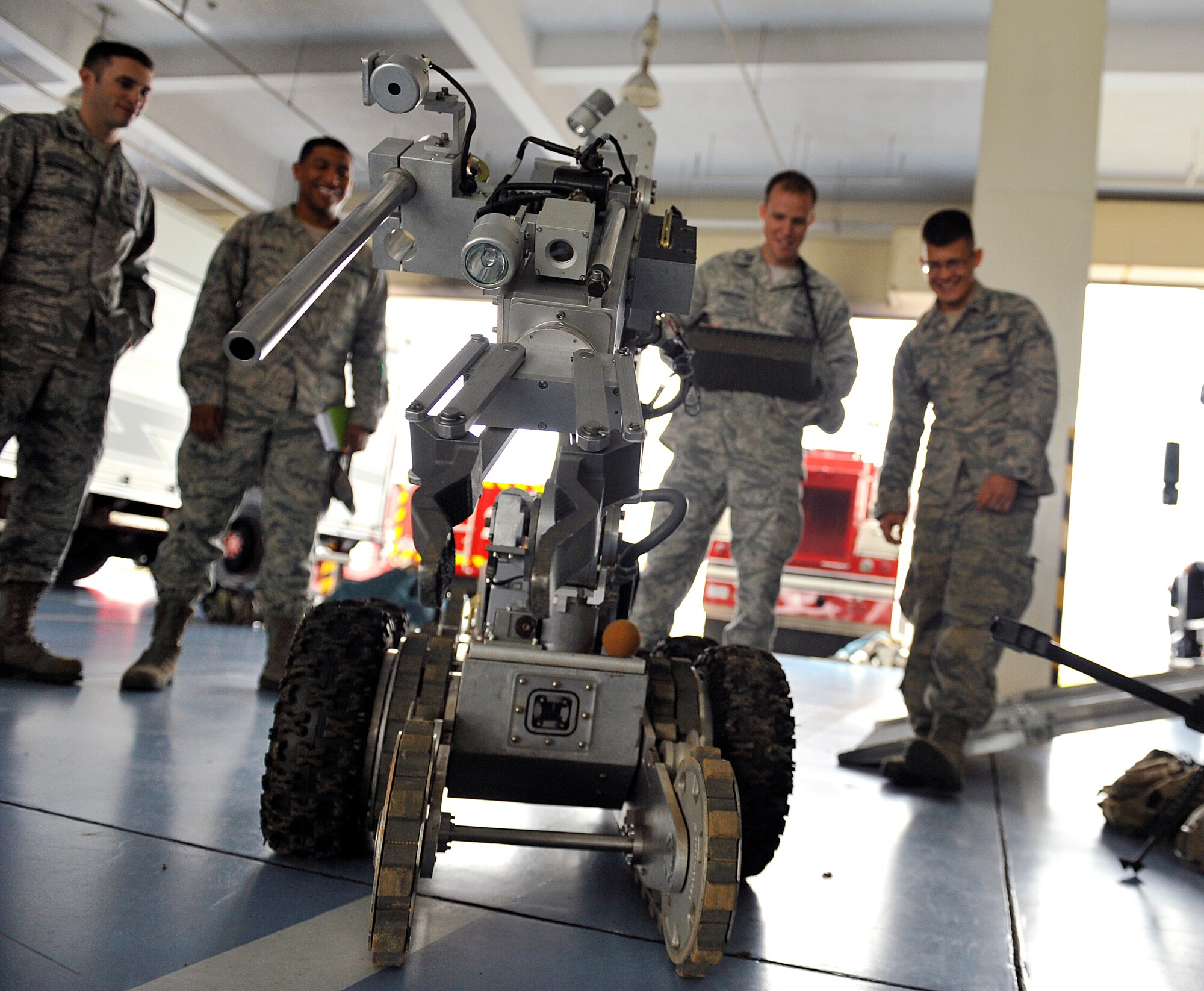 U.S. Air Force Capt. Kendal Forrester, 909th Aircraft Maintenance Unit officer in charge, tries to operate an explosive ordnance disposal robot during the Model Program on Kadena Air Base, Japan, March 25, 2015. The Model Program observed firefighting emergency equipment, hazardous material decontamination, and explosive ordinance disposal with the Kadena Fire Department and 18th CES Explosive Ordinance Disposal flight. (U.S. Air Force photo by Naoto Anazawa)