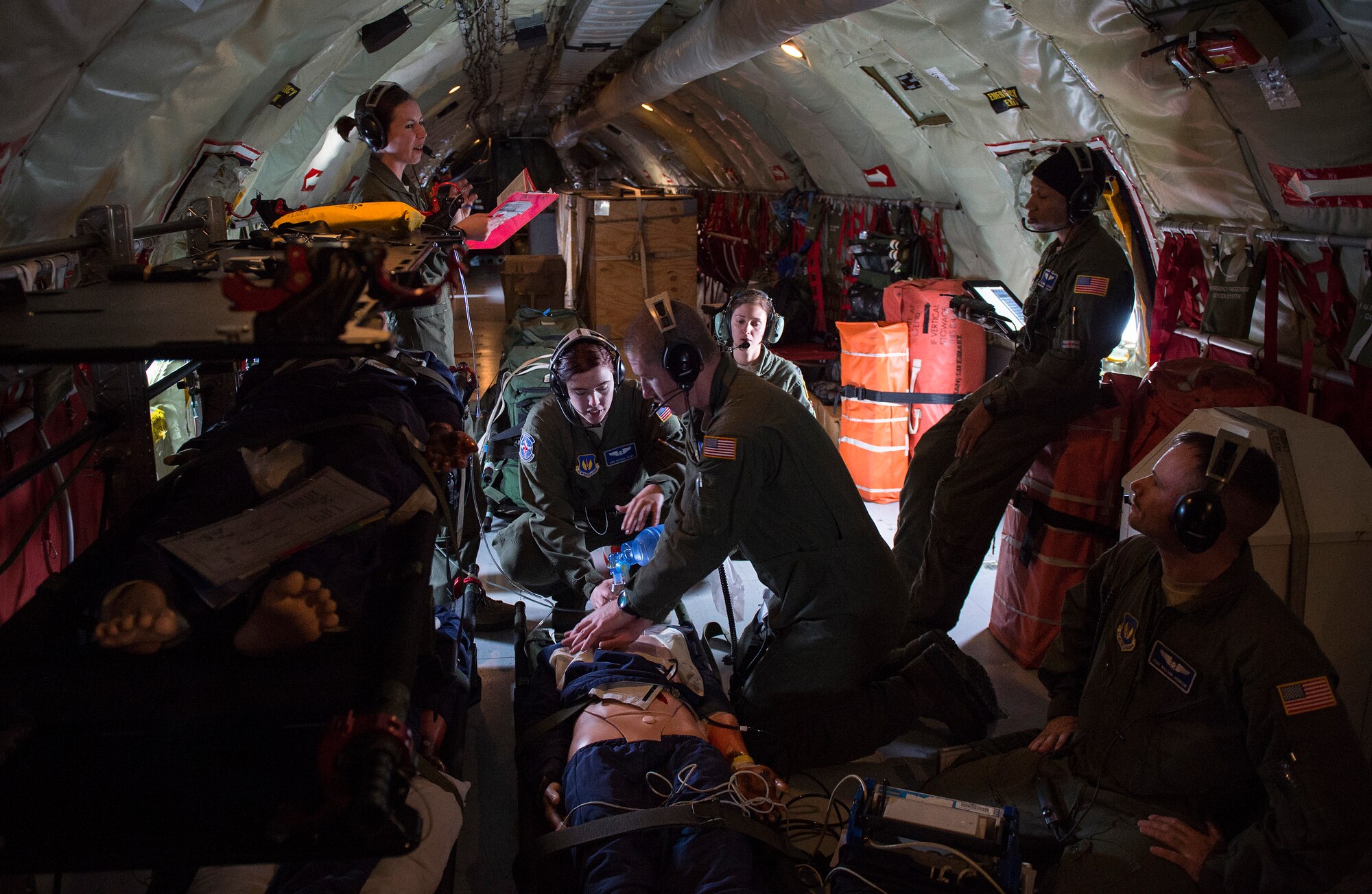 Airmen of the 86th Aeromedical Evacuation Squadron perform lifesaving procedures to a “patient” in a KC-135 Stratotanker, at Ramstein Air Base, Germany, March 26, 2015. Aircrew and a KC-135 from Royal Air Force Mildenhall, England, spent multiple days at Ramstein performing aerial refueling missions, which also gave AES Airmen the opportunity to train on their mission inside a different airframe. (U.S. Air Force photo/Senior Airman Damon Kasberg)