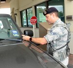 Senior Airman Fredric Bantin, 902nd Security Forces Squadron entry controller, checks a
registration and inspection sticker March 25 at Joint Base San Antonio-Randolph. The new “Two Steps, One Sticker” program began in the state of Texas March 1. Texas drivers no longer receive inspection stickers, and drivers’ registration stickers issued after that date will serve as proof for both inspection and registration. (U.S. Air Force photo by Harold China)