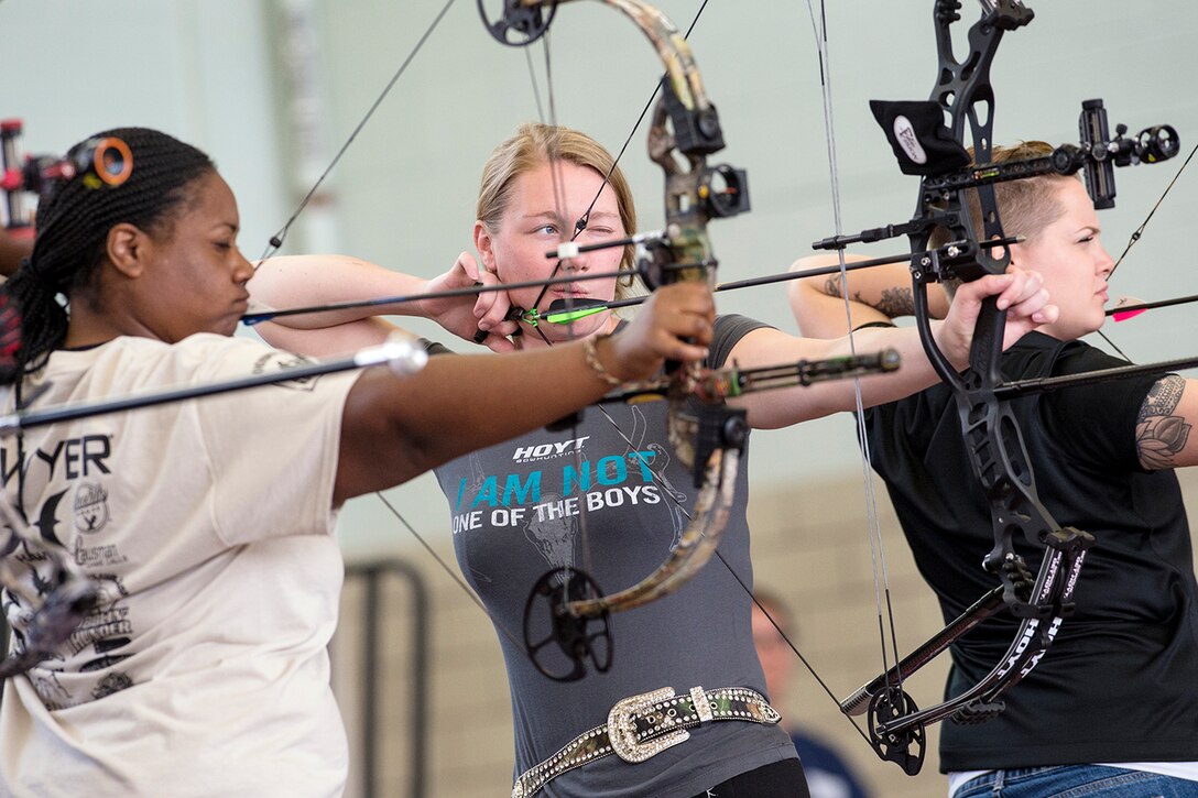 Jasmine Perry, Chasity Kuczer and Laurel Cox compete in the first women’s archery category in Warrior Games history during the 2015 Army Trials on Fort Bliss in El Paso, Texas, March 31, 2015. About 100 wounded, ill or injured soldiers and veterans are on the base to train and compete in athletic events, which include archery, cycling, shooting, sitting volleyball, swimming, wheelchair basketball and track and field, through April 2. The trials help determine who will get a spot on the Army's team for the Defense Department Warrior Games 2015 in June on Marine Corps Base Quantico, Va.