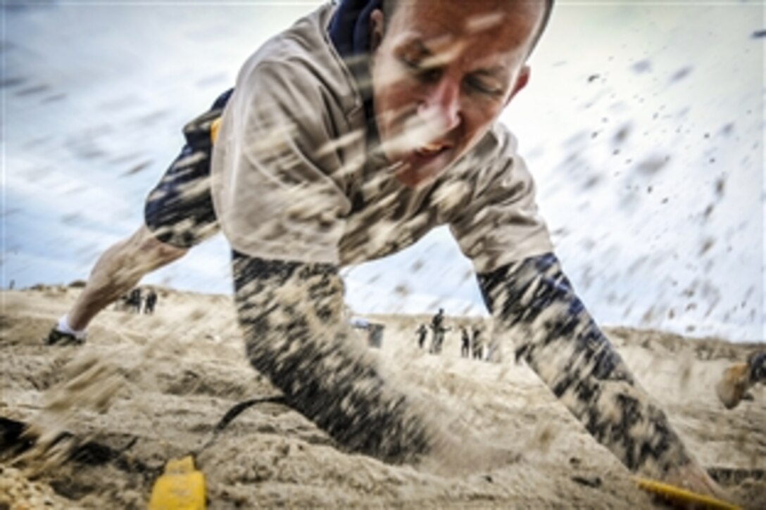 Navy Chief Petty Officer Alexander Thomas shuffles across an obstacle during the 2015 Goat Locker Challenge on Joint Expeditionary Base Little Creek-Fort Story in Norfolk, Va., March 30, 2015. The event commemorates the 122nd birthday of the rank of chief petty officer in the Navy.