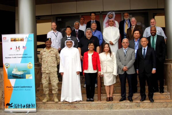 Participants in a partnering meeting take a moment to pose for a group photo March 17.