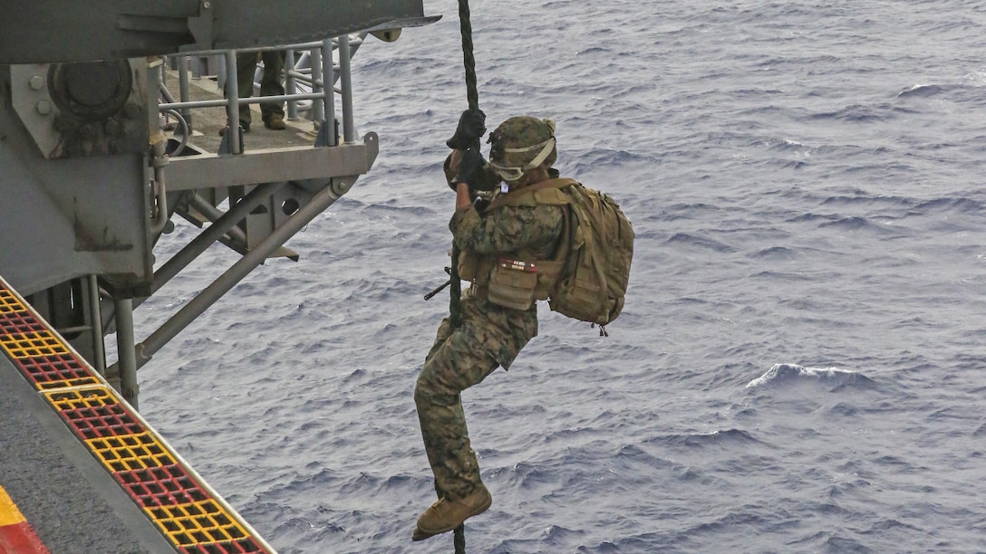 A U.S. Marine fast-ropes out of an MV-22B Osprey during an exercise on the flight deck of the USS Bonhomme Richard, at sea, Feb. 18, 2015. Each Marine had a chance to go down the rope multiple times. After fast-roping, the Marines practiced rappelling from the Osprey. The Marines are with Weapons Co., Battalion Landing Team 2nd Battalion, 4th Marine Regiment, 31st Marine Expeditionary Unit, and the Osprey is from Marine Medium Tiltrotor Squadron 262. The Marines are currently participating in the MEU’s annually-scheduled Spring Patrol of the Asia-Pacific region. 