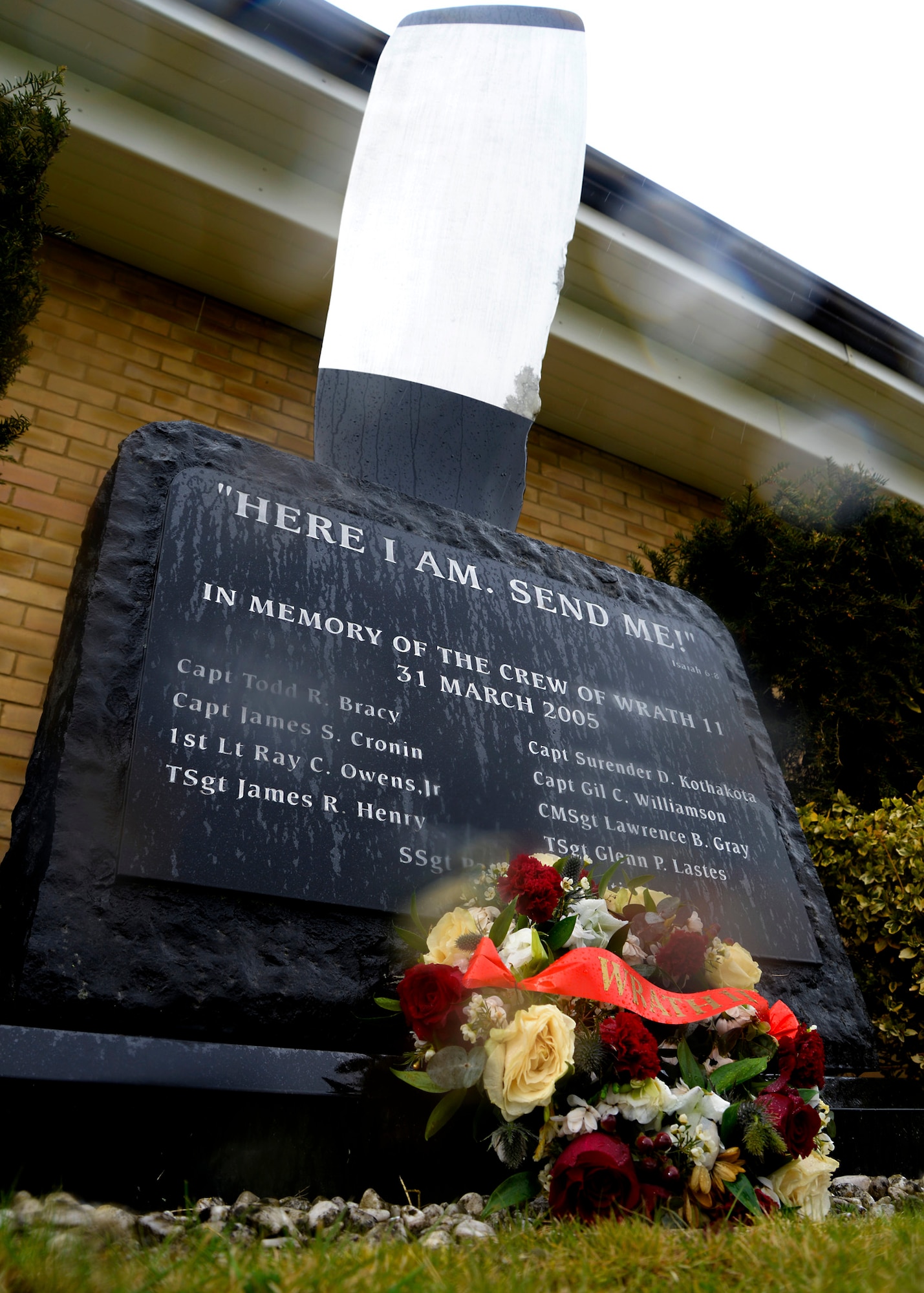 A wreath lies at the foot of the Wrath-11 memorial monument March 31, 2015, following a remembrance ceremony on RAF Mildenhall, England. The WRATH-11 memorial monument displays the names of the nine Airmen who perished when an MC-130H Combat Talon II assigned to the 7th Special Operations Squadron, crashed in Albania during a training exercise in 2005. (U.S. Air Force photo by Senior Airman Victoria H. Taylor)