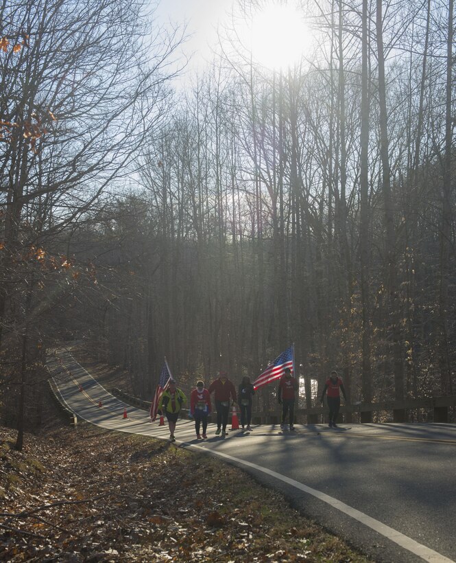 Members of Team RWB motivate runners participating in the Marine Corps 17.75K run in Prince William Forest Park, Va., March 28, 2015. Finishers of the 17.75 kilometer recieved a Guaranteed Access Code to this year's 40th Marine Corps Marathon in October. (U.S. Marine Corps photo by Cpl. Daniel Benedict/Released)