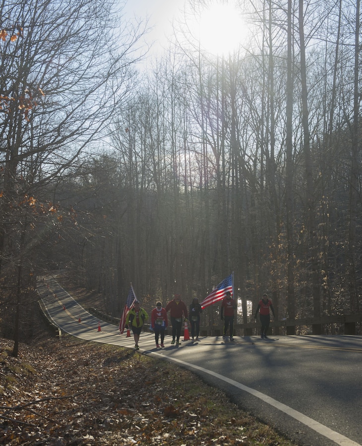 Members of Team RWB motivate runners participating in the Marine Corps 17.75K run in Prince William Forest Park, Va., March 28, 2015. Finishers of the 17.75 kilometer recieved a Guaranteed Access Code to this year's 40th Marine Corps Marathon in October. (U.S. Marine Corps photo by Cpl. Daniel Benedict/Released)