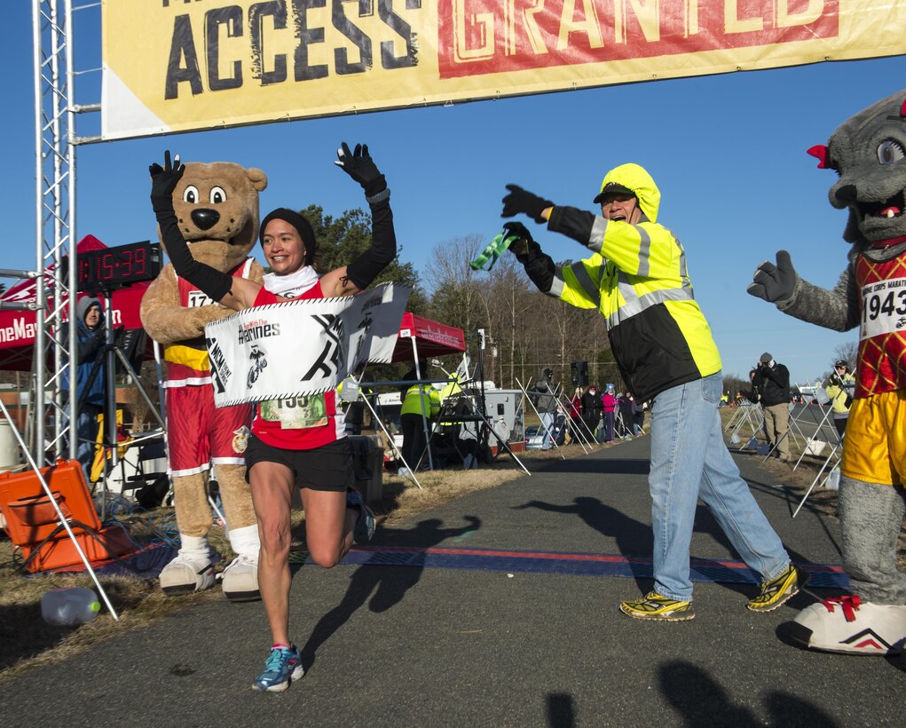 Anna Bernal runs passed the finish line of  the Marine Corps 17.75k in Prince William County, Va., on March 28, 2015. Bernal finishes in first place for the females and ninteenth overall, finsihing the 11 mile trek in one hour, fifteen minutes and twenty seconds. (U.S. Marine Corps Photo by Lance Cpl. Jacqueline A. Garcia/ Released) 