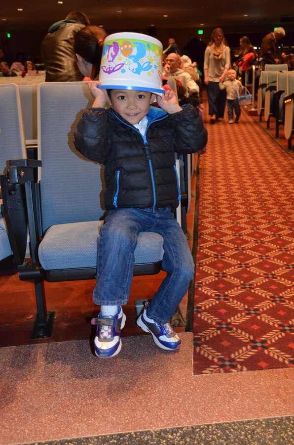 Liano, 4, waits with his bucket for the indoor Easter activities to start in the movie theater at Little Hall on Saturday.