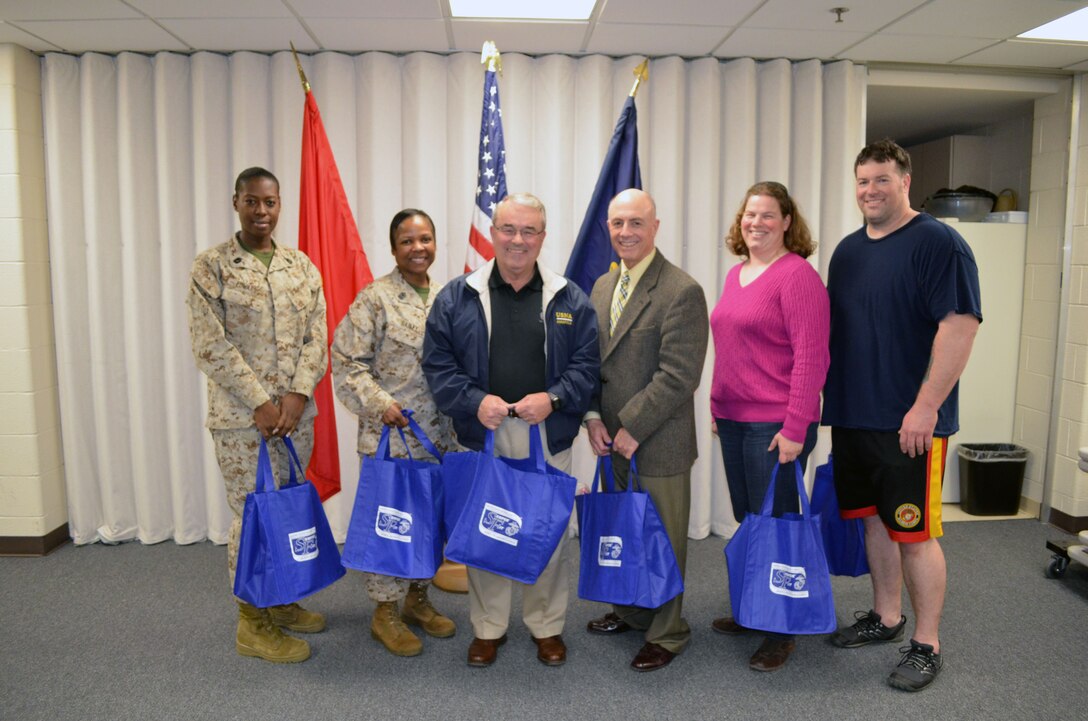 The teams and individual winners coming in first and second in the Semper Fit Slimpossible fitness challenge pose for a group photo with their prize packs at the awards ceremony on March 26. 