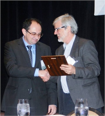 The Society for Risk Analysis (SRA) President Ortwin Renn, right, presents the Outstanding Practitioner Award to ERDC-EL Research Physical Scientist Dr. Igor Linkov at the SRA’s annual meeting Dec. 10 in Denver, Colorado. This award is presented to one SRA member each year for outstanding risk analysis practices.