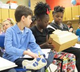 Monte Sano Elementary School students examine architectural model.