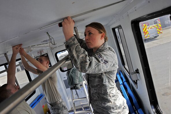U.S. Air Force Airman 1st Class Brianna Brown, 35th Logistics Readiness Squadron vehicle and vehicular maintenance journeyman, removes the metal framing on the inside of a medical transport vehicle at Misawa Air Base, Japan, March 27, 2015. This was part of a job to fix the lighting system inside the vehicle, which is designed to transport mass casualty patients. (U.S. Air Force photo by Senior Airman Jose L. Hernandez-Domitilo/Released)