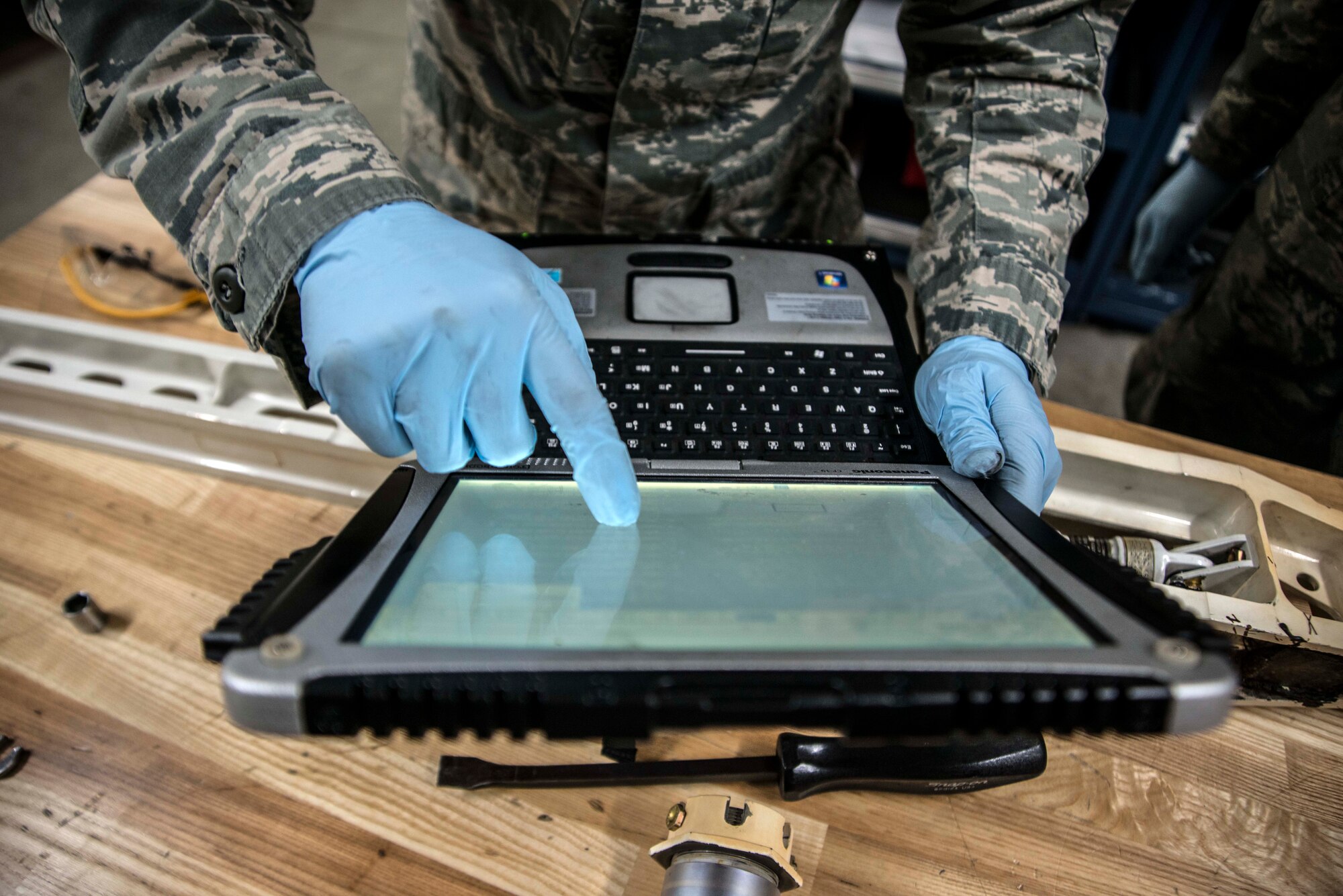 Staff Sgt. Brian Argenti, 35th Maintenance Squadron hydraulics systems craftsman, reviews a technical order during maintenance March 31, 2015, at Misawa Air Base, Japan. Argenti repaired an F-16 Fighting Falcon's landing gear system, one of the common jobs of within the hydro back shop. (U.S. Air Force photo by Staff Sgt. Derek VanHorn/Released)
