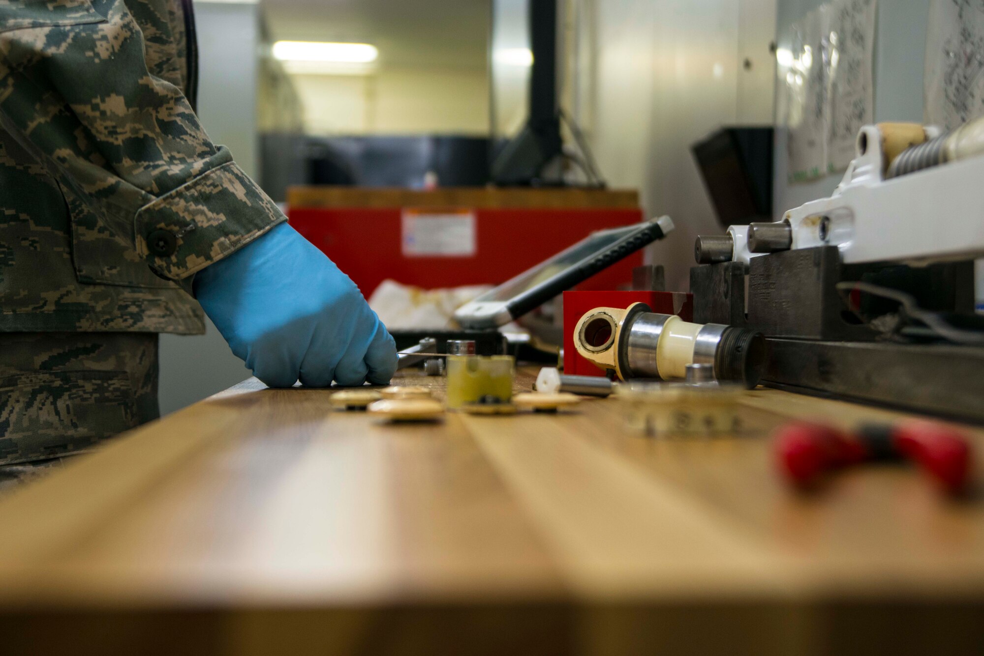 A maintainer from the 35th Maintenance Squadron prepares tools for maintenance on a landing gear system March 31, 2015, at Misawa Air Base, Japan. Hydraulics systems maintainers completed more than 30 landing gear overhauls for F-16 Fighting Falcons at Misawa during 2014. (U.S. Air Force photo by Staff Sgt. Derek VanHorn/Released)