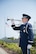 Airman 1st Class Robert Cook, Travis Honor Guard, plays taps as the family of Master Sgt. Robert Foster, a World War II veteran and former prisoner of war is laid to rest at the Sacramento Valley National Cemetery in Dixon, California on March 31, 2015. Foster is joins more than 20,000 military veterans buried at the cemetery. (U.S. Air Force photo/Ken Wright)
