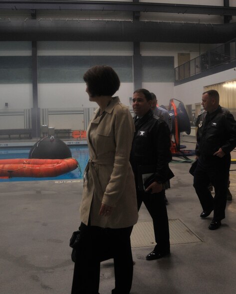 Congresswoman Cathy McMorris Rodgers, U.S. Representative for Washington's 5th congressional district, surveys some survival rafts through the fog created by the humidity in the Aquatics Center while on a tour led by Col. Jonathan Duncan, 336th Training Group commander, and Col. Brian McDaniel, 92nd Air Refueling Wing commander, April 1, 2015, at Fairchild Air Force Base, Wash. McMorris Rodgers received a demonstration by U.S. Air Force Survival School students, showing what they would do if a plane they were in crashed in a large body of water. The Aquatics Center is used for recreational and lap swimming as well as an indoor water survival training facility capable of simulating waves, thunder and lightning, wind and other conditions aircrew might encounter. (U.S. Air Force photo/Airman 1st Class Taylor Bourgeous)