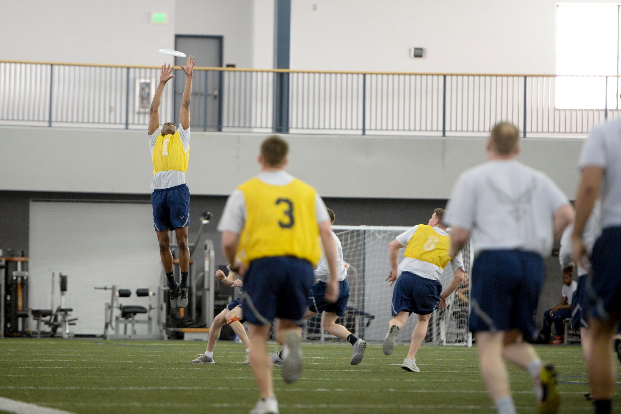 Eielson Airmen play a game of ultimate frisbee during the 354th Fighter Wing Sports Day at Eielson Air Force Base, Alaska, March 30, 2015. The 354th Communications Squadron took first place in the frisbee tournament. (U.S. Air Force photo by Senior Airman Peter Reft/Released)