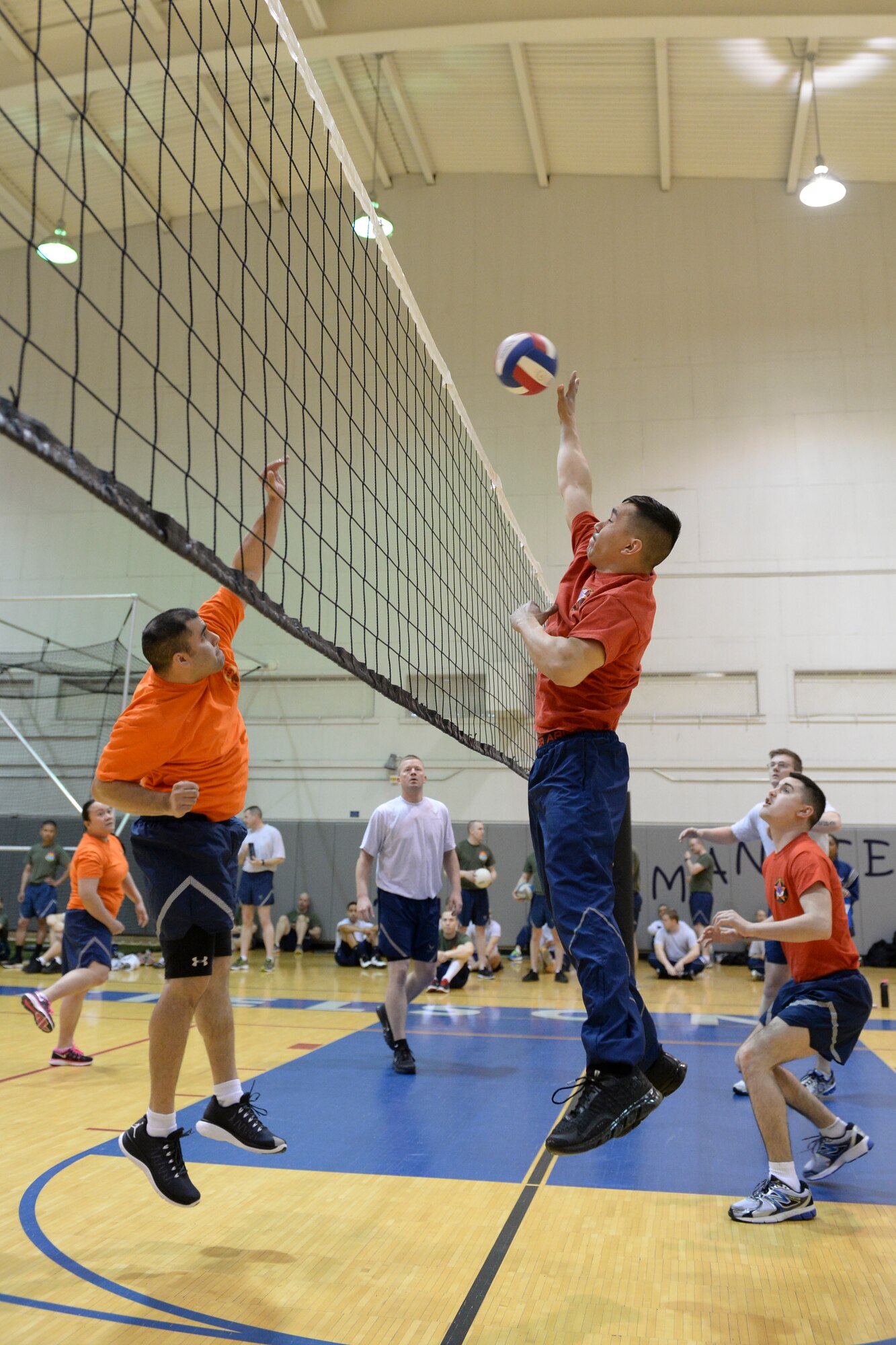 U.S. Airmen assigned to the 354th Maintenance Squadron and the 354th Combat Training Squadron compete against each other during a 354th Fighter Wing Sports Day volleyball game at Eielson Air Force Base, Alaska, March 30, 2015. Sports Day was held to build teamwork, camaraderie and friendly competition among teams and units on base. (U.S. Air Force photo by Senior Airman Peter Reft/Released)