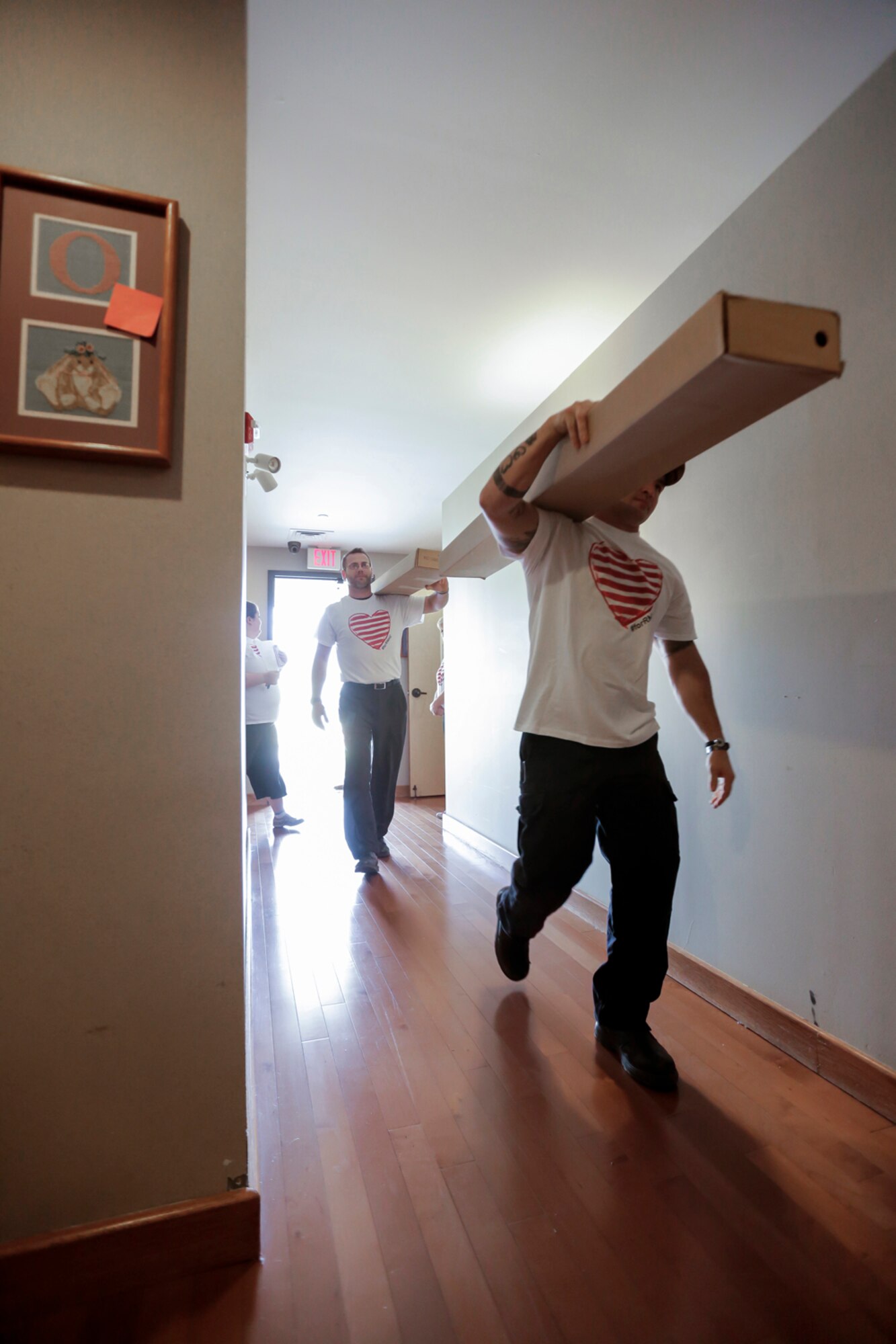 Members of the 138th Fighter Wing (FW) carry bed frames to waiting bedrooms March 29, 2015, at the Ronald McDonald House of Tulsa.  Volunteers from the 138th Fighter Wing assisted at the house upon the arrival of a large shipment new beds and mattresses. (U.S. National Guard photo by Master Sgt. Mark A. Moore/Released)