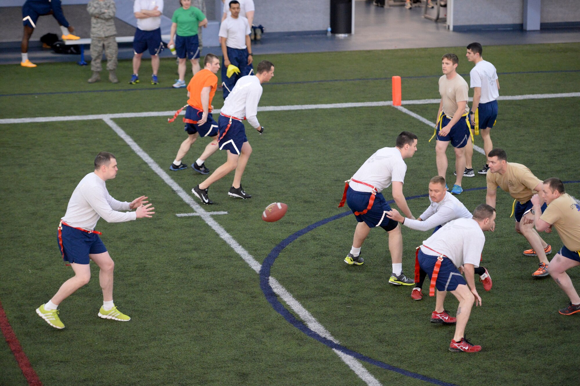 U.S. Airmen assigned to the 354th Maintenance Squadron compete against Airmen assigned to the 1st Air Support Operations Group during a 354th Fighter Wing Sports Day flag football game at Eielson Air Force Base, Alaska, March 30, 2015. The 354th Logistics Readiness Squadron took first place in the flag football tournament. (U.S. Air Force photo by Senior Airman Peter Reft/Released)