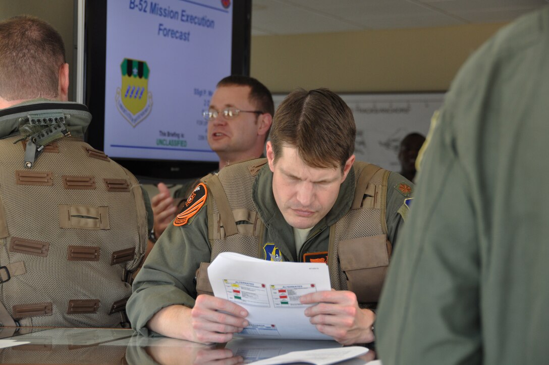 U.S. Air Force Maj. Landon Bell, 343rd Bomb Squadron, studies a flight brief at the 2nd Bomb Wing Operations Center. Major Bell is part of an aircrew participating in the “Polar Growl” mission. “Polar Growl” is a command directed Total Force Enterprise training mission bringing together active duty and reserve personnel from both the 2nd and 307th Bomb Wings at Barksdale Air Force Base, La. This long range exercise is over the Arctic and North Sea regions. (U.S. Air Force photo by Master Sgt. Laura Siebert/Released)